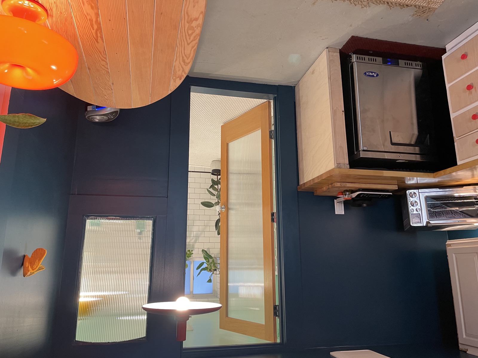 Cooking area with window to garden and small refrigerator