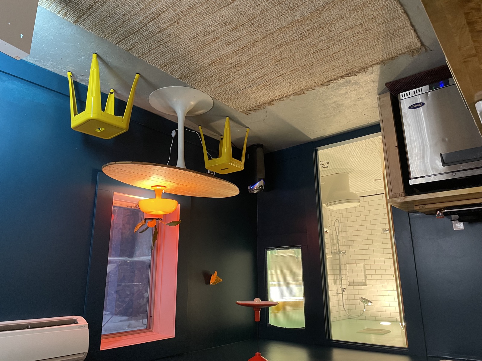 Desk and eating area with yellow pendant lights and blue walls