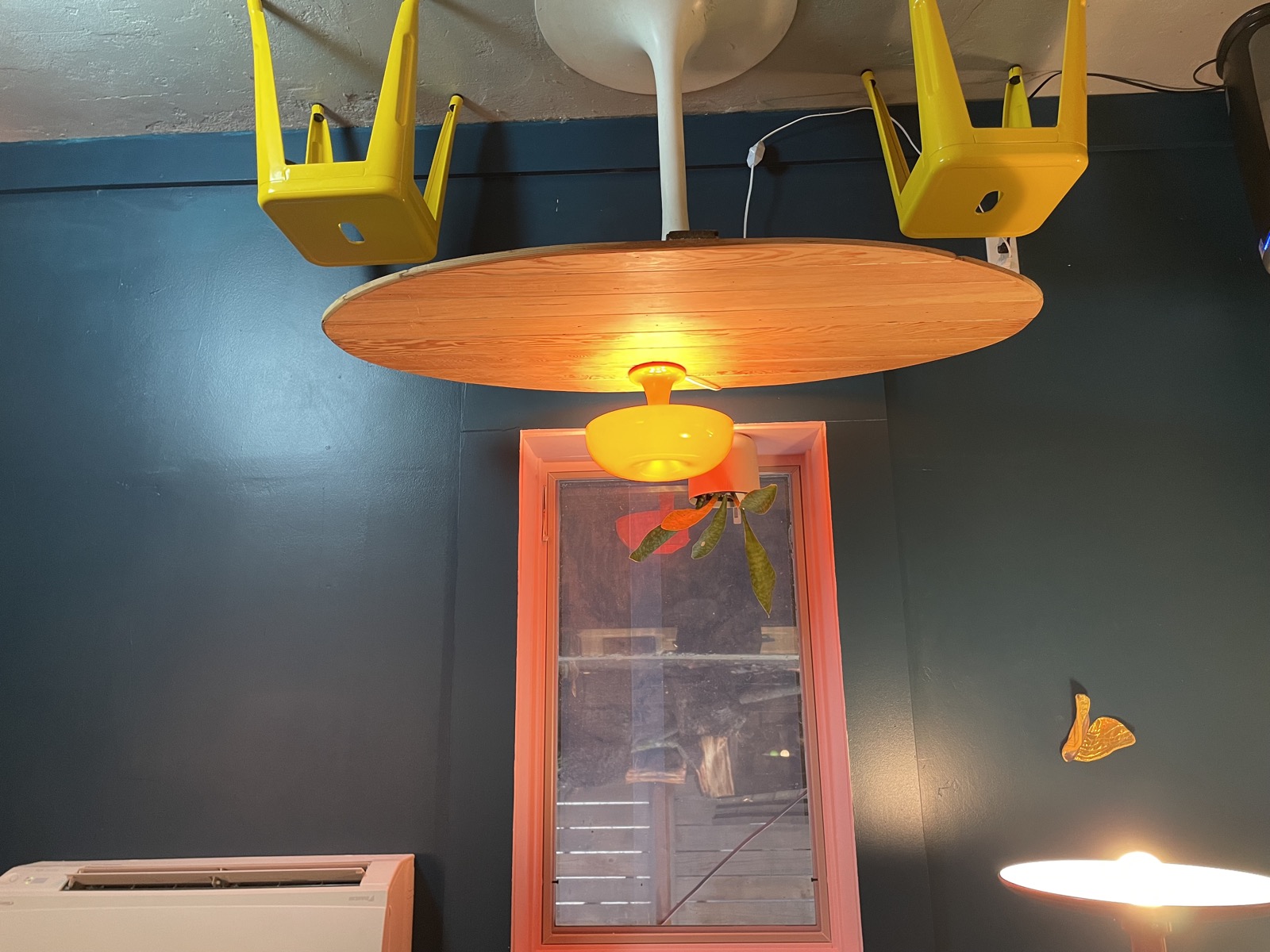 Dining area with vintage pendant lamp and colorful wall art