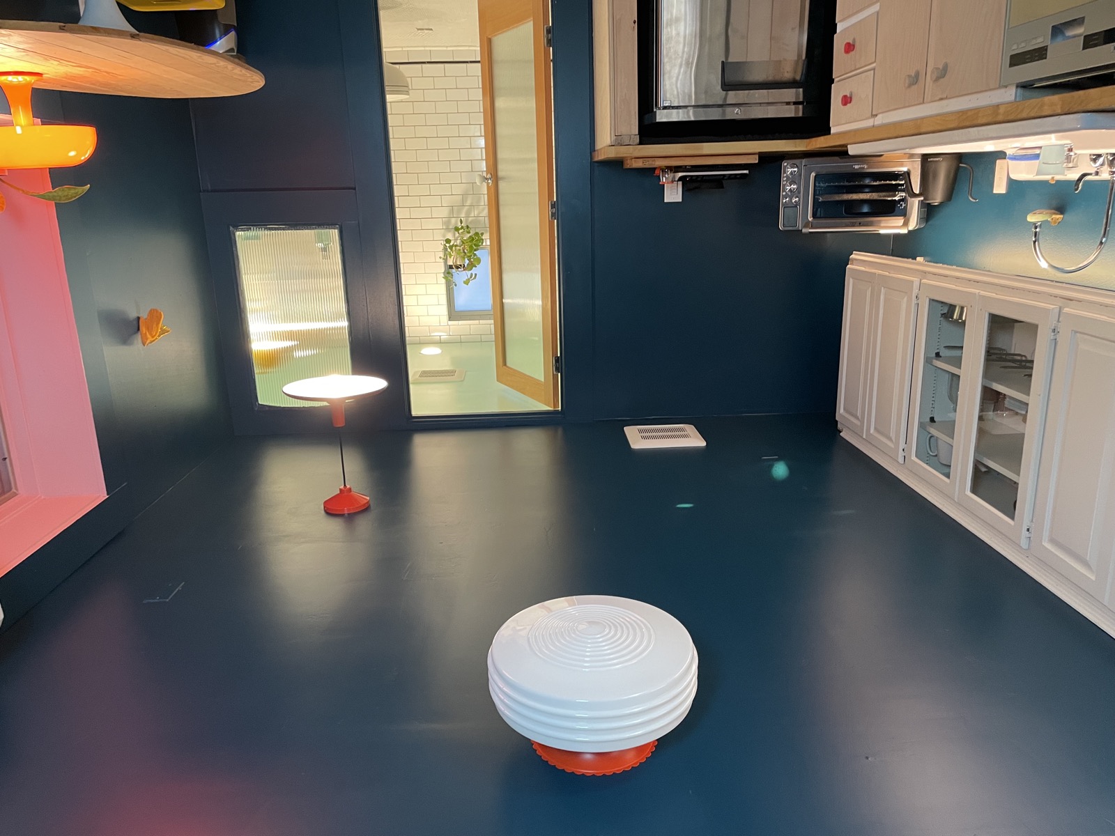 Open plan view of kitchenette and bathroom entrance