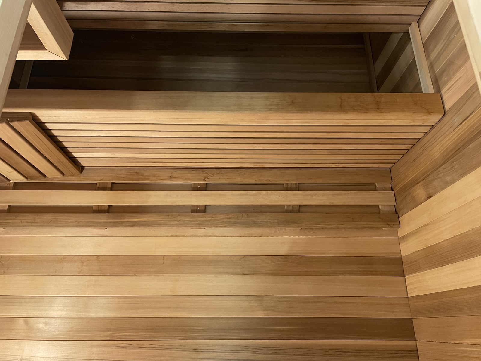 Sauna heater with stones and cedar wall detail
