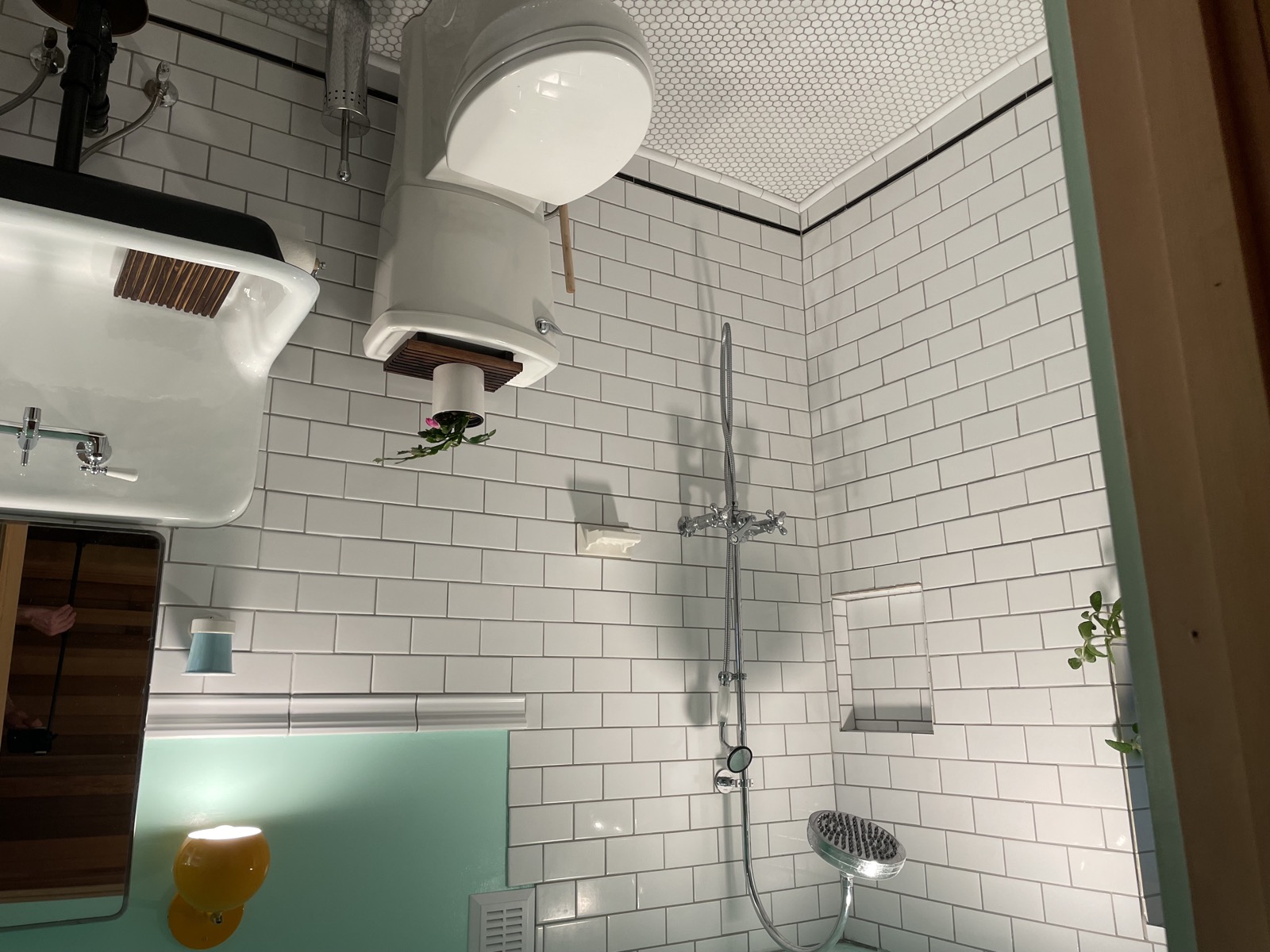 Bathroom with white subway tile walls, rain shower, and teal floor